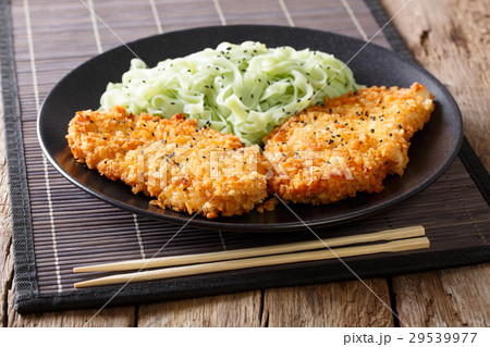 Chicken cutlet in breadcrumbs and green noodles Chicken cutlet in breadcrumbs and green noodles 29539977