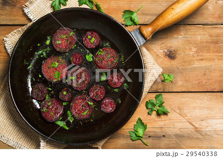Fried beet slices on a cast-iron frying pan Fried beet slices on a cast-iron frying pan 29540338