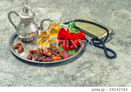 Tea, red rose flower, dates, holy book quran Tea, red rose flower, dates, holy book quran 29542583