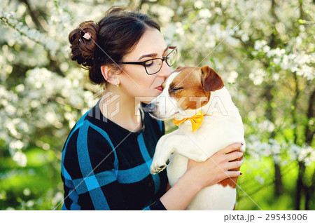 Young beautiful woman kisses her beloved pet dog 29543006