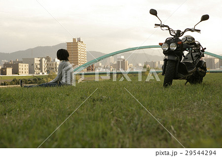 バイクと河川敷の女性 29544294