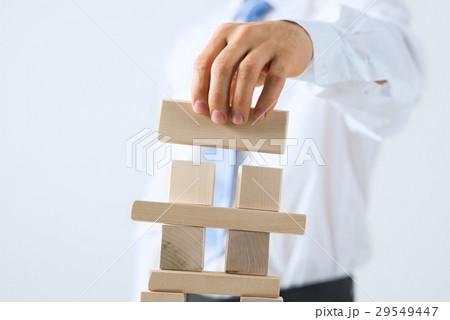 Businessman making tower Businessman making tower 29549447