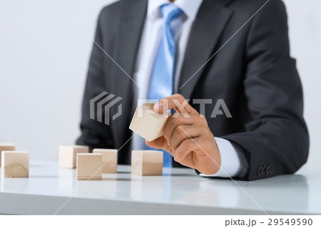 Businessman making tower Businessman making tower 29549590