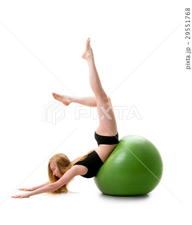 Female gymnast poses on stomack on green fitball 29551768