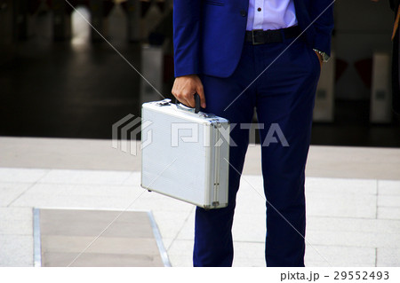 Man is holding metallic brief case 29552493