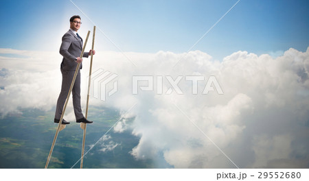 Businessman walking on stilts - standing out from 29552680