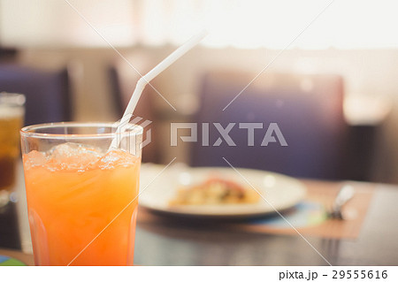 Orange juice with blur breakfast background. 29555616