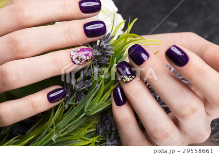 Shot beautiful manicure with flowers on female 29558661
