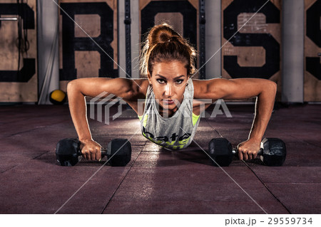 Female exercising at gym. Female exercising at gym. 29559734