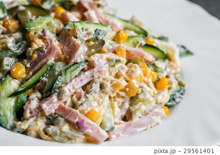 salad with ham on white plate. selective focus salad with ham on white plate. selective focus 29561401