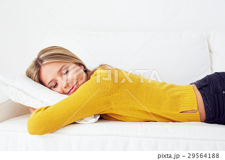 Beautiful woman sleeps on a white sofa Beautiful woman sleeps on a white sofa 29564188