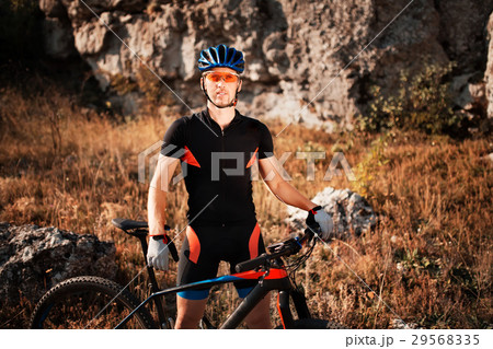 Portrait of a cyclist in helmet and sunglasses on Portrait of a cyclist in helmet and sunglasses on 29568335