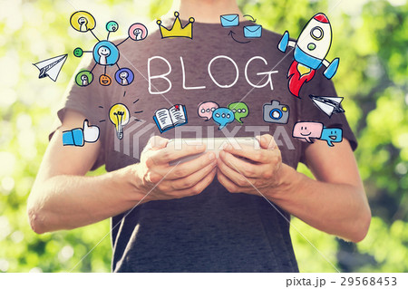 BLOG concept with young man holding his smartphone BLOG concept with young man holding his smartphone 29568453