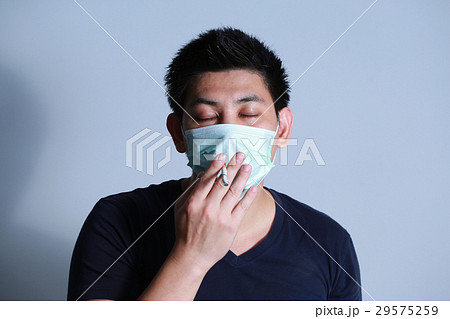 young man smoking cigarette with  protective mask 29575259