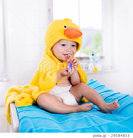 Baby in bath towel with tooth brush 29584833