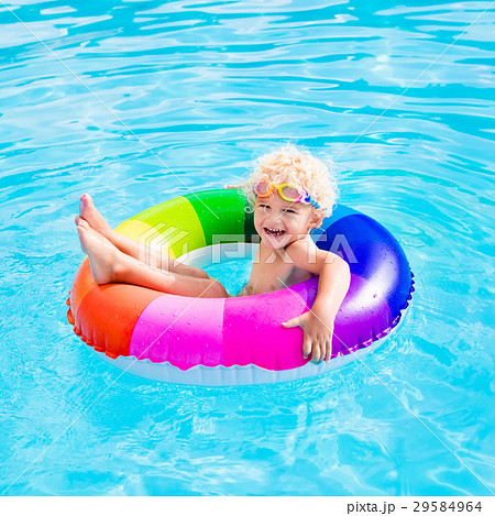 Child with toy ring in swimming pool Child with toy ring in swimming pool 29584964