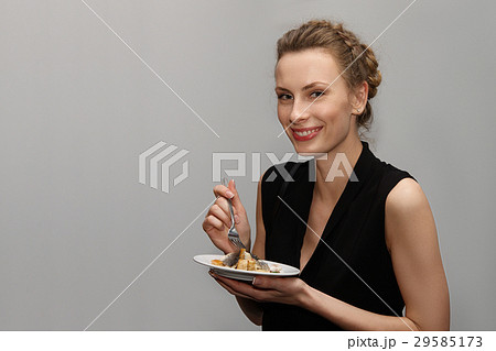 Pretty Girl With Plate In Hand Eating Fried の写真素材