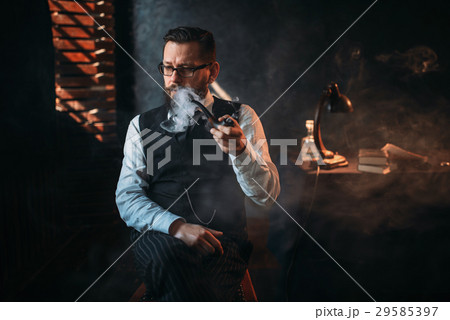 Portrait of man sitting on chair and smoking pipe 29585397