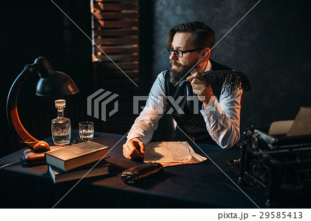 Bearded writer in glasses smoking a pipe 29585413