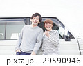 車の前で会話してる20代カップル 29590946