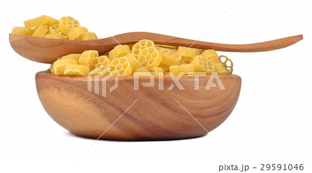 Uncooked italian pasta rotelle in a wooden bowl 29591046