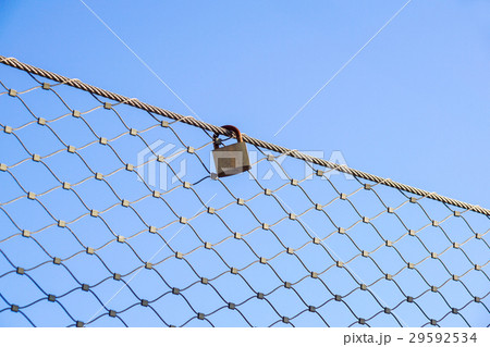 close up a key lock hook on iron wire gates and close up a key lock hook on iron wire gates and 29592534