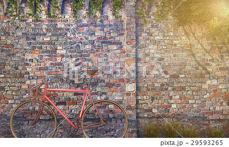 red bicycle near antique brick wall 29593265