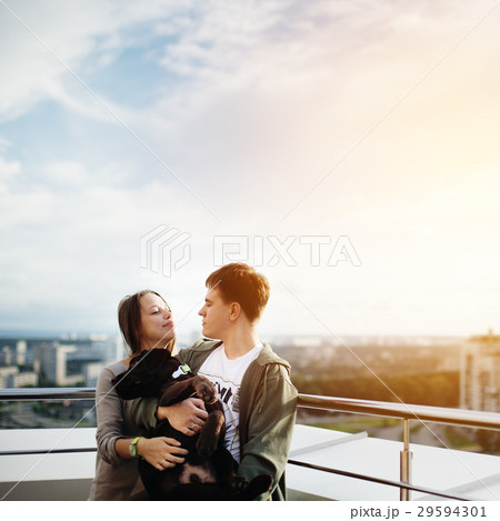 Couple walking with dog outdoors Couple walking with dog outdoors 29594301