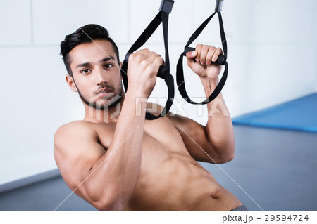 Young man training with TRX Young man training with TRX 29594724