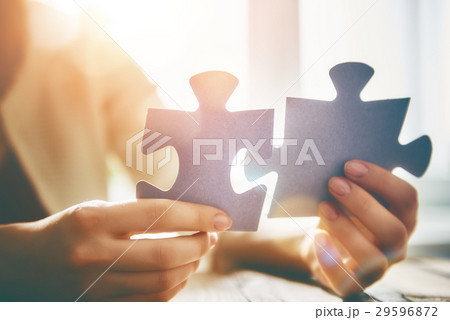 Woman connects couple puzzle piece 29596872