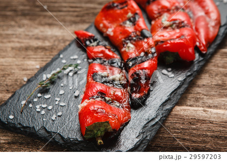 Juicy fresh grilled paprika served on wood table Juicy fresh grilled paprika served on wood table 29597203