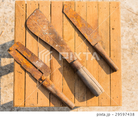 Rusty knifes on wooden tiles, farmer equipment Rusty knifes on wooden tiles, farmer equipment 29597438