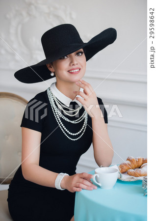 Woman in hat, much like the famous actress Woman in hat, much like the famous actress 29598642