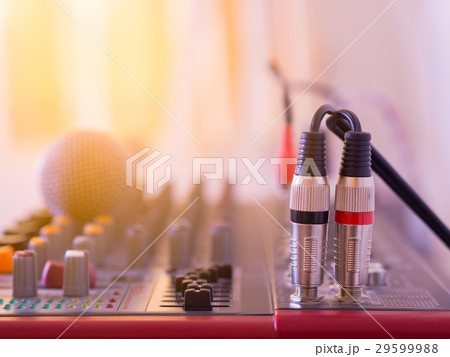 Audio jack cable connected on music mixer. 29599988