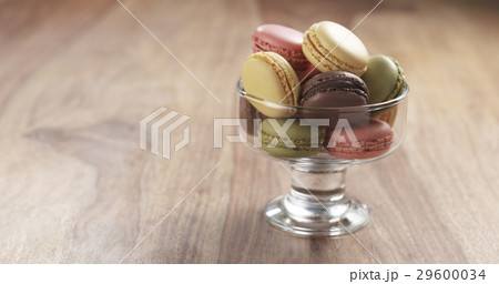 mixed macarons in glass bowl on table mixed macarons in glass bowl on table 29600034