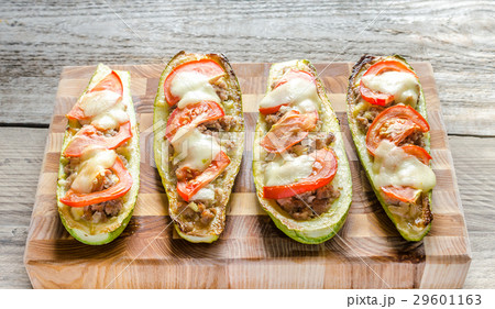 Stuffed zucchini on the wooden board Stuffed zucchini on the wooden board 29601163