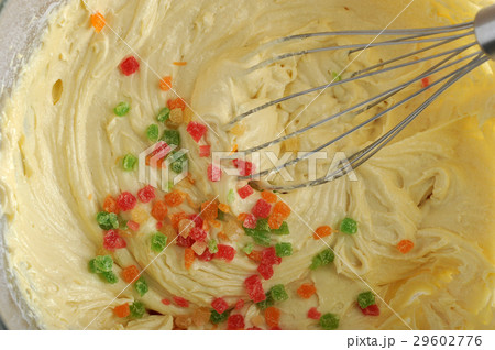 mixing dough for cake in a bowl with candied fruit mixing dough for cake in a bowl with candied fruit 29602776