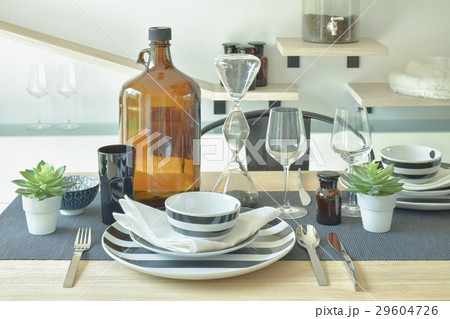 crockery and wine bottle setting on dining table crockery and wine bottle setting on dining table 29604726