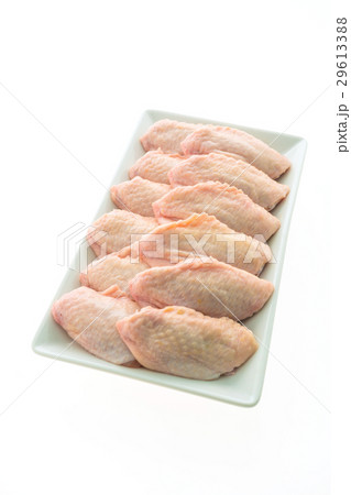 Raw chicken meat and wing in white plate 29613388