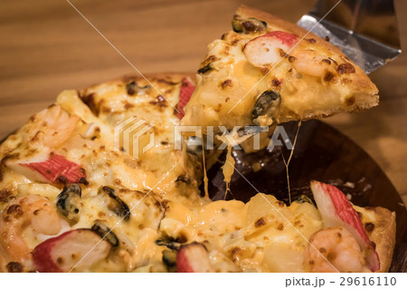 Delicious seafood pizza on a wooden textured table 29616110