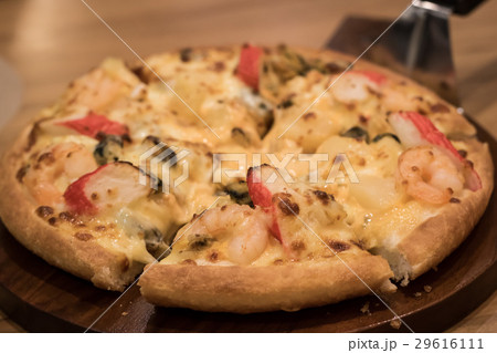 Delicious seafood pizza on a wooden textured table 29616111