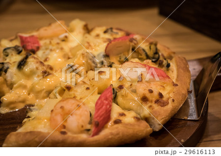 Delicious seafood pizza on a wooden textured table 29616113