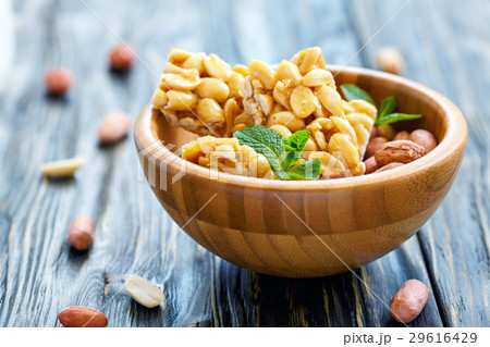 Honey bars with peanuts and mint in a round bowl. 29616429