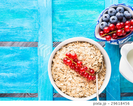 Rolled Oats and berries blue textured background Rolled Oats and berries blue textured background 29618456