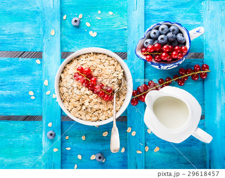 Rolled Oats and berries blue textured background Rolled Oats and berries blue textured background 29618457