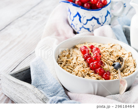 Raw rolled oats with fresh berries on wooden table 29618464
