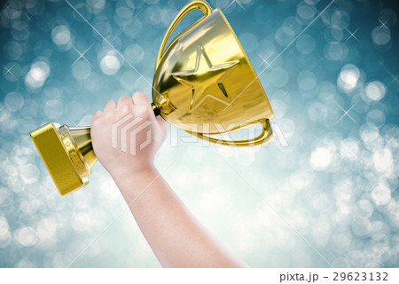 hand holding golden trophy hand holding golden trophy 29623132