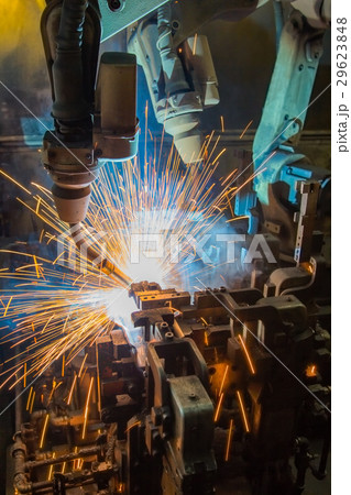 Team robots are welding assembly part in factory 29623848