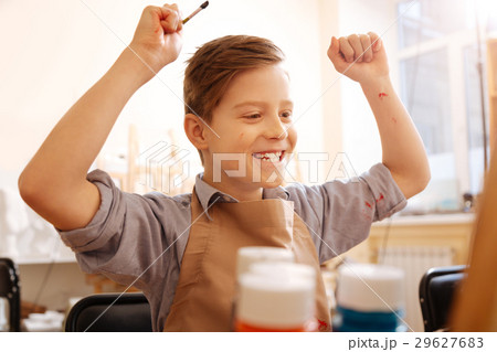 Cheerful boy expressing happiness in the school Cheerful boy expressing happiness in the school 29627683