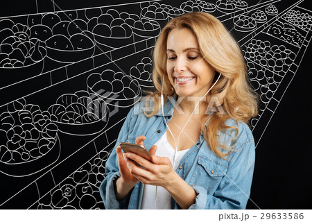 Joyful pretty woman choosing a song 29633586
